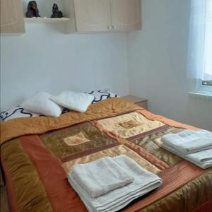 a bed with blankets and towels on top of it at BRZOZOWY GAJ AGROTURYSTYKA in Bobryk