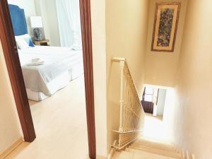 A bed or beds in a room at HomeySeville-Penthouse Cathedral Tomas de Ibarra St 6 pax, Parking Optional