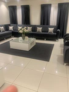 a living room with a couch and a coffee table at Jamal Royal Apartments in Medina