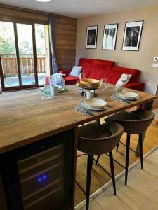 a living room with a table with chairs and a couch at Gorgeous 2 bedroom, 2 full bath, ski in apartment! in Morzine