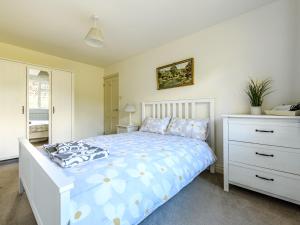 a bedroom with a white bed and a dresser at 2 Orchard Leigh in Austwick