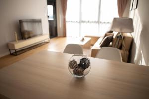 a glass bowl of rocks sitting on top of a table at LINA - PG, Riverside Apartment in Podgorica