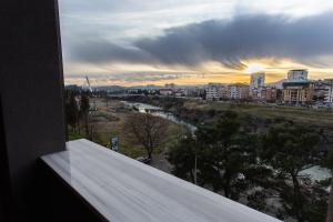 a view from a window of a city with a river at LINA - PG, Riverside Apartment in Podgorica