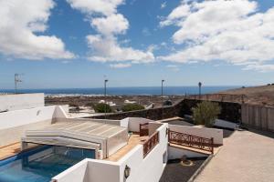 a view of the ocean from the roof of a house at CASA MORRO BLANCO in Tías