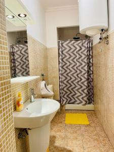 a bathroom with a sink and a toilet and a mirror at Hostel Stari Grad in Novi Sad