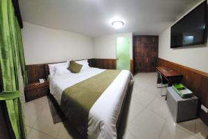 Voodi või voodid majutusasutuse Apartahotel Vincent Suites toas