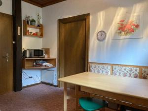 a room with a table and a clock on the wall at Apartment Lilla in Millstatt