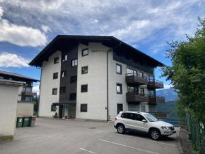 a white car parked in front of a building at Apartment Lilla in Millstatt