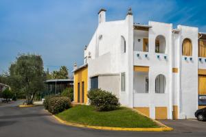 バレンシナ・デ・ラ・コンセプシオンにあるApartamento Aljarafeの黄色のアクセントが施された白い建物