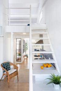 a white loft bed in a living room with oranges at Apartamento Aljarafe in Valencina de la Concepción