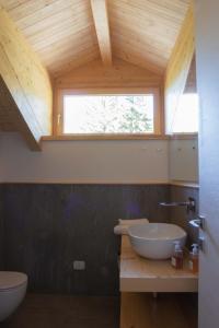 a bathroom with a sink and a window at B&B Villa Cavallier in Barzio