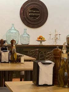 a table with glass bottles on top of it at Santa Lucía Casa Hotel in Villa de Leyva