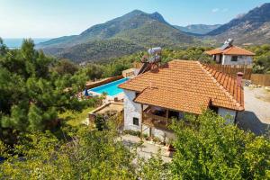 an external view of a house with a swimming pool at Secret Haven Villa in Fethiye