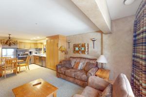 a living room with a couch and a table at Shoshone 1930 in Big Sky