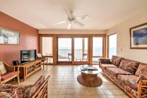 a living room with a couch and a tv at Oceanfront Kailua-Kona Townhome with Pool and Views! in Kailua-Kona