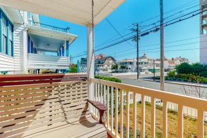 a porch of a house with a swing at Ocean City Stunner in Ocean City