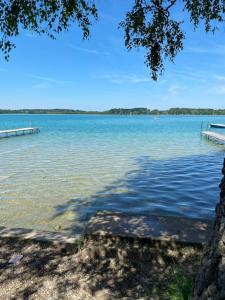 a large body of water with two docks in it at See-Appartement Wörthsee in Wörthsee