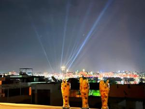 a view of a city skyline at night at Gold Ibis Hotel in Luxor