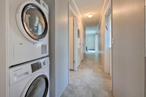a laundry room with a washer and dryer next to a hallway at Cassopolis Cabin On-Site Boating and Fishing! in Cassopolis
