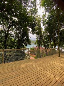 a wooden deck with a view of the water at Aquário Glamping in Abraão