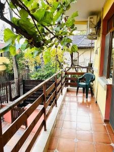 a balcony of a house with a chair and a table at Casa Bia in Iaşi