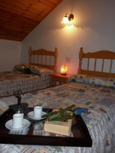a bedroom with two beds and a table with a book at Apartaments Noray in Barruera