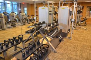 a gym with a bunch of treadmills and machines at Hanover Post Oak in Houston