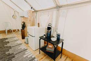 a room with a refrigerator and a table in it at Timberline Glamping at Unicoi State Park in Helen