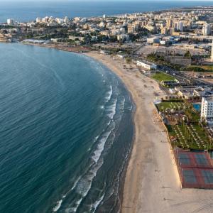 an aerial view of a beach and the ocean at Ali Baba's Cave - Acre's Hidden Treasure in ‘Akko