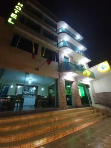 a building with stairs in front of it at night at Apartahotel Vincent Suites in Pasto