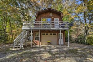 a tiny house with a porch and a deck at Sky Loft Bryson Studio 1 Mi From Fontana Lake! in Bryson City