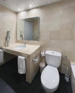 a bathroom with a toilet and a sink and a mirror at Stay U-nique Apartments Beltrán i Rózpide in Barcelona