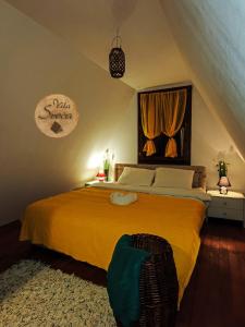 Vila Sreća - Kolašin في كولاسين: غرفة نوم بسرير اصفر كبير في العلية