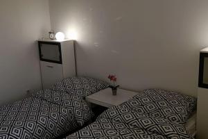a room with two beds and a table in it at Apartmán priamo v centre mesta Levice in Levice