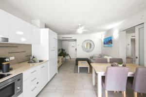 a kitchen and living room with a table and a dining room at Hotel Drift 4202 in Palm Cove