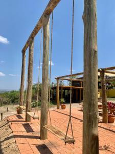 a swing set in a playground at Casa Erva Doce Pousada in Delfinópolis +9 photos