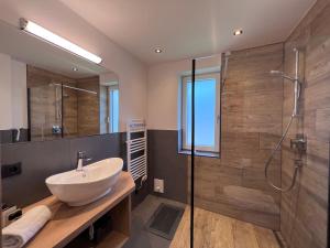 uma casa de banho com um lavatório e um chuveiro em Apartments Monika - Altenmarkt em Altenmarkt im Pongau