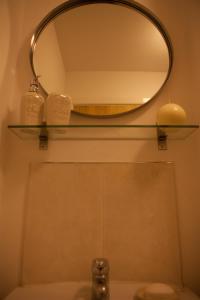 a mirror above a bathroom sink with two candles at Station Suite – Simple2let Serviced Apartments in Halifax