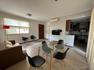 a living room with a couch and a table and chairs at Departamento Quinta N in Mendoza