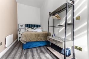 a bedroom with a bed and a wooden floor at Comfy and Contemporary One Bedroom Flat in London