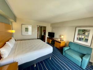 a hotel room with a bed and a blue couch at Ala Moana Hotel 31st floor in Honolulu