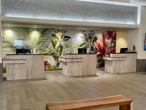 a lobby with a mural of plants on the wall at Ala Moana Hotel 31st floor in Honolulu