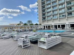 a hotel patio with lounge chairs and a pool at Ala Moana Hotel 31st floor in Honolulu