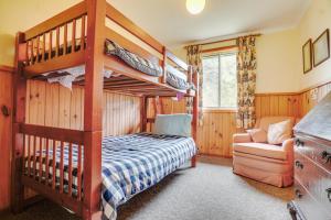 a bedroom with a bunk bed and a couch at Eureka Farm in Scamander