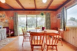 a dining room with a table and chairs at Eureka Farm in Scamander