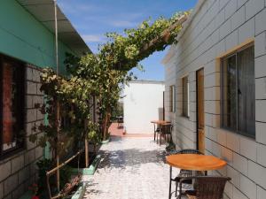 an alley with a table and chairs and a building at Altos del Lascar in Toconao