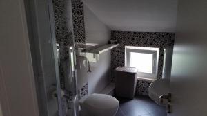 a small bathroom with a toilet and a window at Apartments Kutlic in Cavtat +33 photos