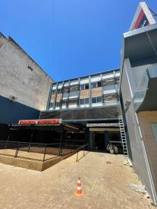 a building with an orange cone in front of it at Hotel Executivo in São Borja