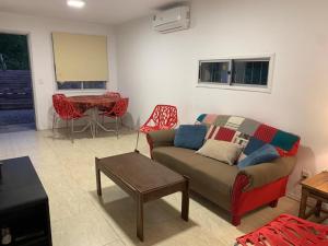a living room with a couch and a table at Philadelphia3 dormitorios in Punta del Este +18 photos