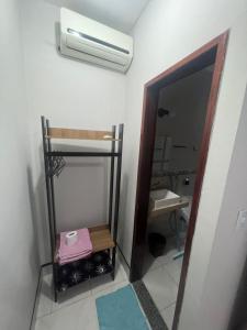 a small bathroom with a toilet and a sink at Ap próximo ao Arco com garagem in Sobral